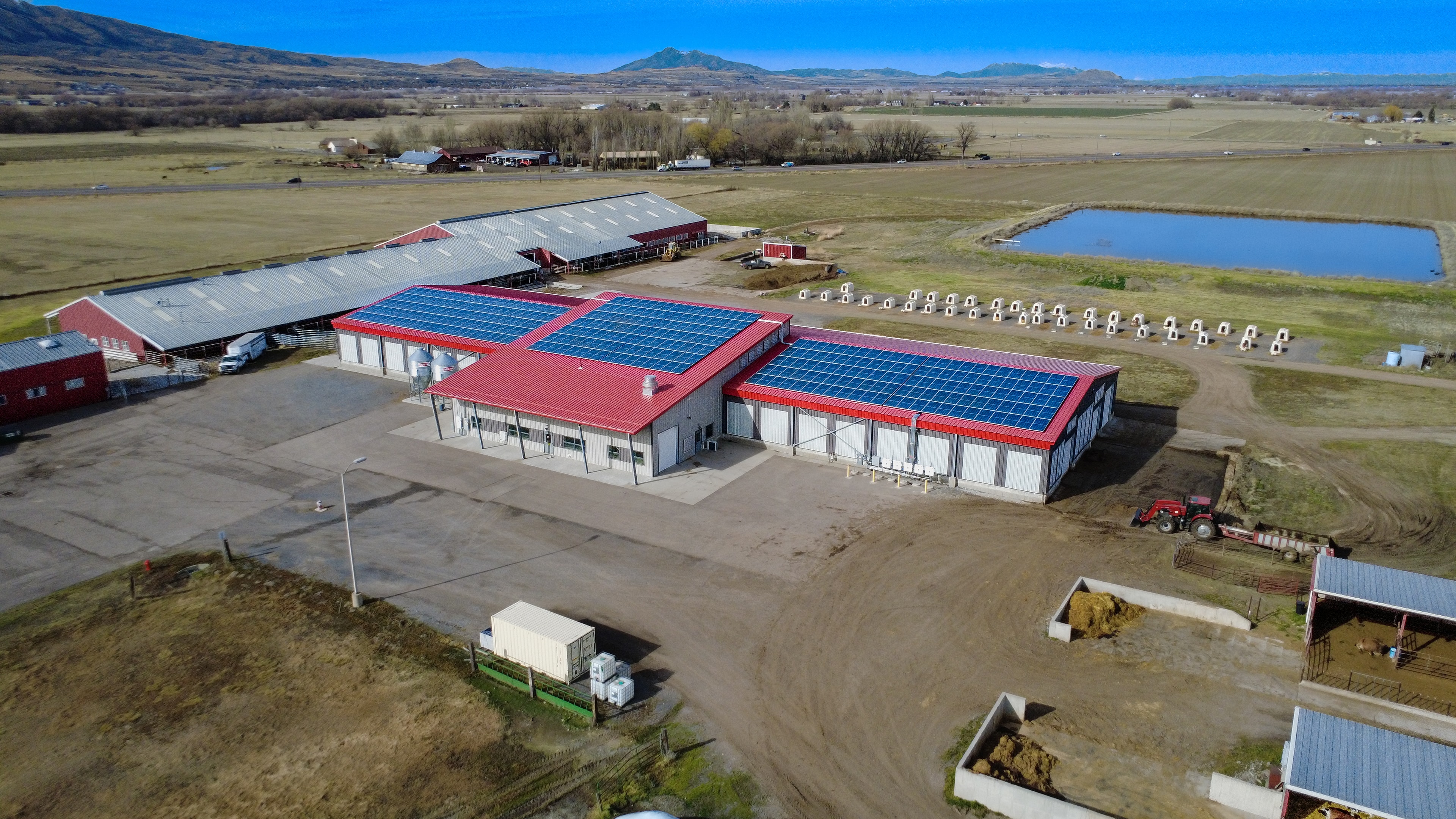 Aerial view of Caine Dairy with rooftop solar panels installed, Utah valley